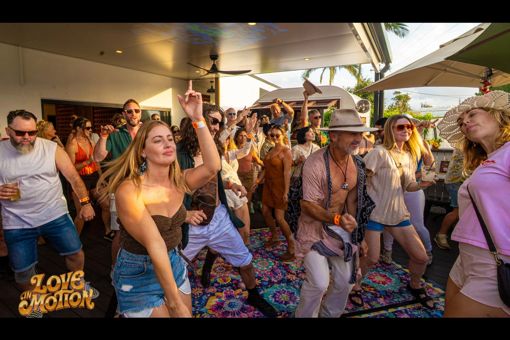 People dancing together at the daytime gathering